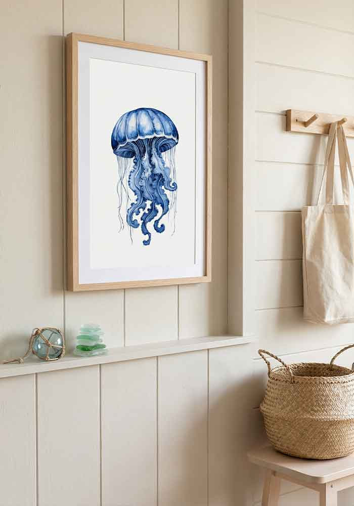 Delicate monochromatic watercolor illustration of a dzwon-shaped jellyfish with trailing tentacles in deep indigo blue, on a plain white background.