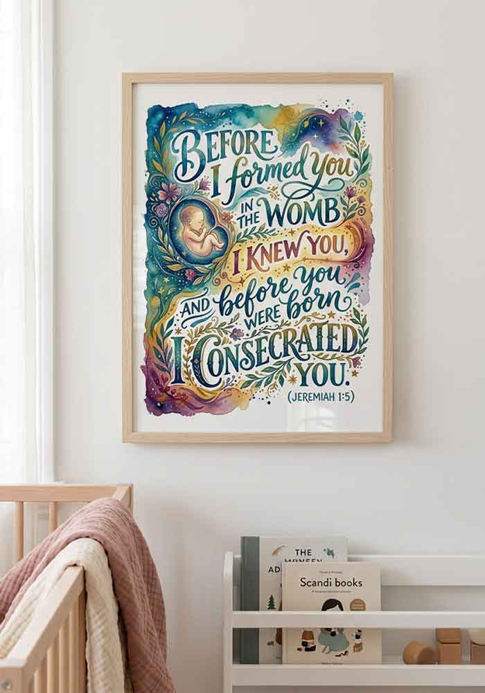 Richly colored watercolor typography poster with the verse "Before I formed you in the womb I knew you... (Jeremiah 1:5)" alongside a delicate illustration of a baby in the womb surrounded by stars and floral swirls.